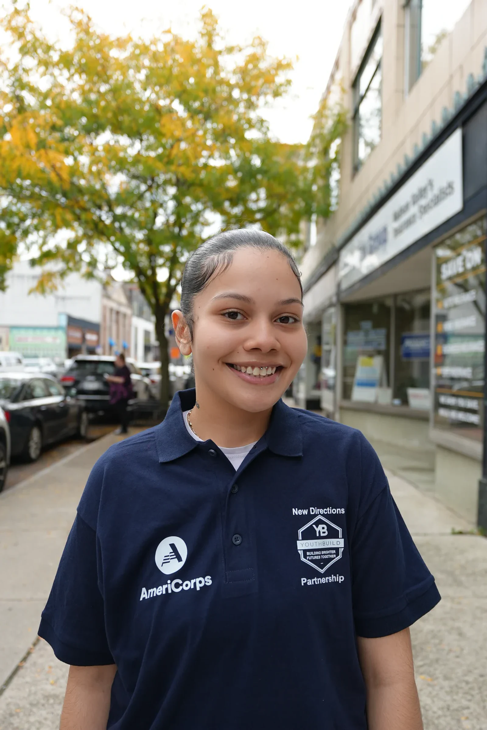YouthBuild participant standing outside on Main Street